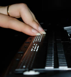fingers on braille keyboard
